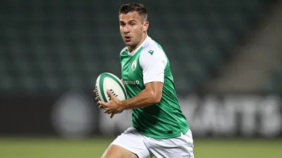 A tight action crop of an anonymous Hvidovre player, aged 25-30, with a build of 1.80m and 75kg, wearing a green jersey...
